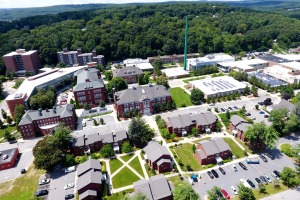 Aerial drone shot of campus buildings from Cedar St facing smokestack