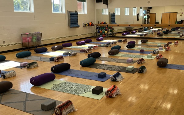 Aerobic studio set up for yoga class with mats and props