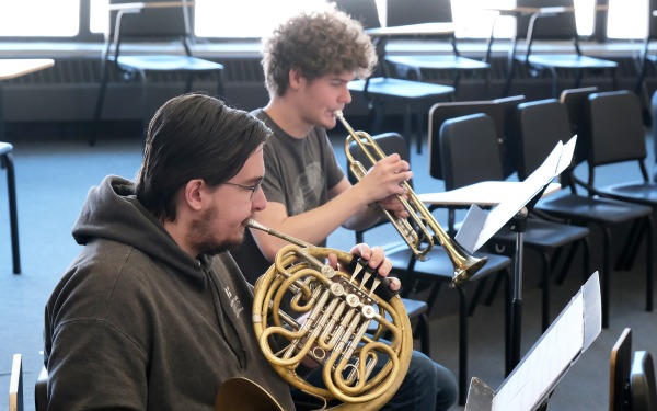 Students playing horns in music room