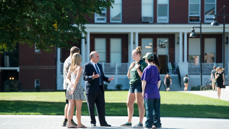President Lapidus speaks with students on the quad 