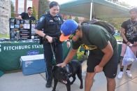 Photo of police dog Odin greeting students with Officer Erin Morreale