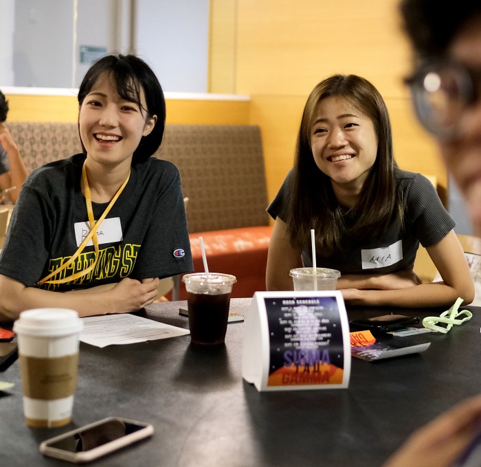 International female students smiling at orientation in Falcon Hub
