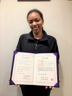 Imani Hunter with a certificate from Reitaku University
