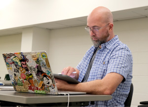 AP summer institute male student with laptop and iPad