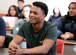 Students in the classroom at tables. 