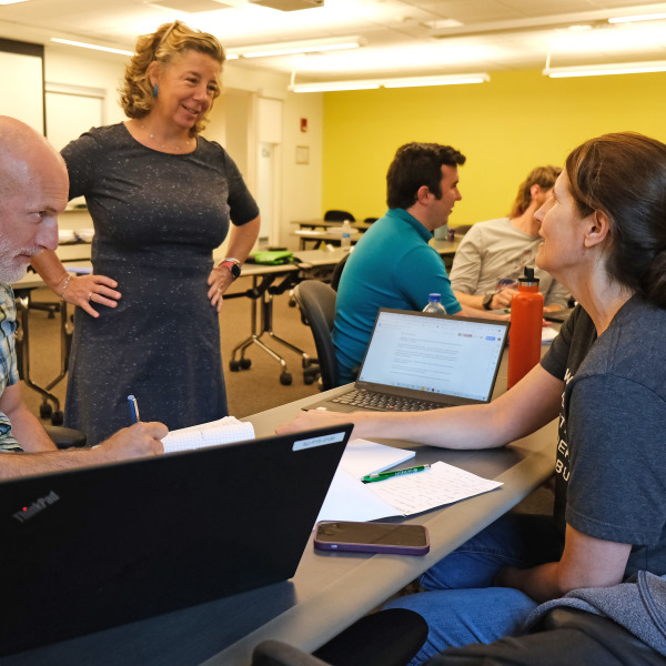 Teacher talking to adult students in AP classroom