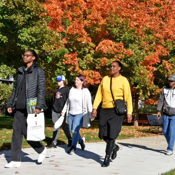Tour groups on quad in front of Science building with fall foliage