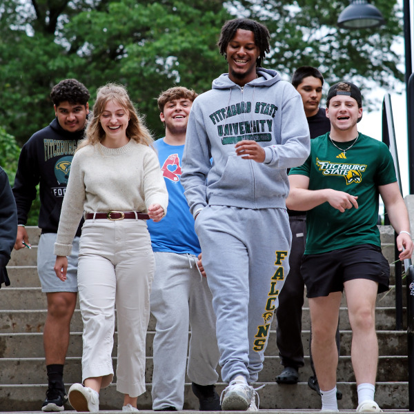 Smiling group of students walking down the stairs