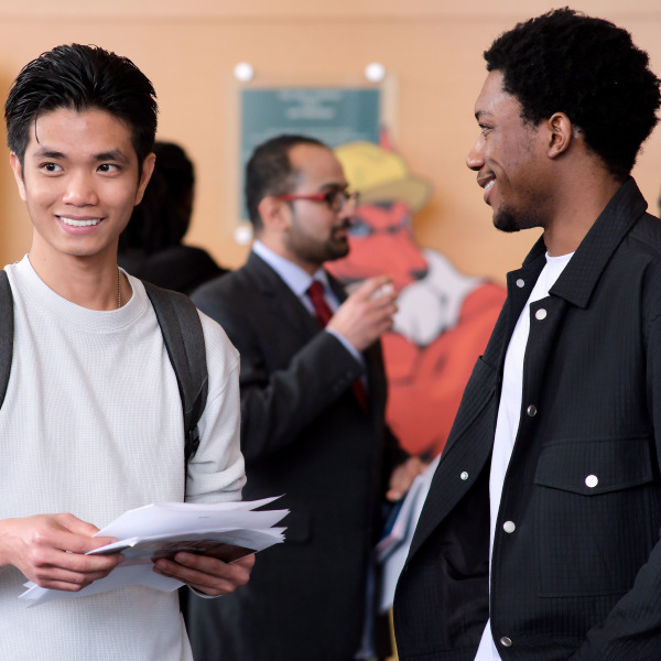Two male students in main lounge at Business Career Fair.