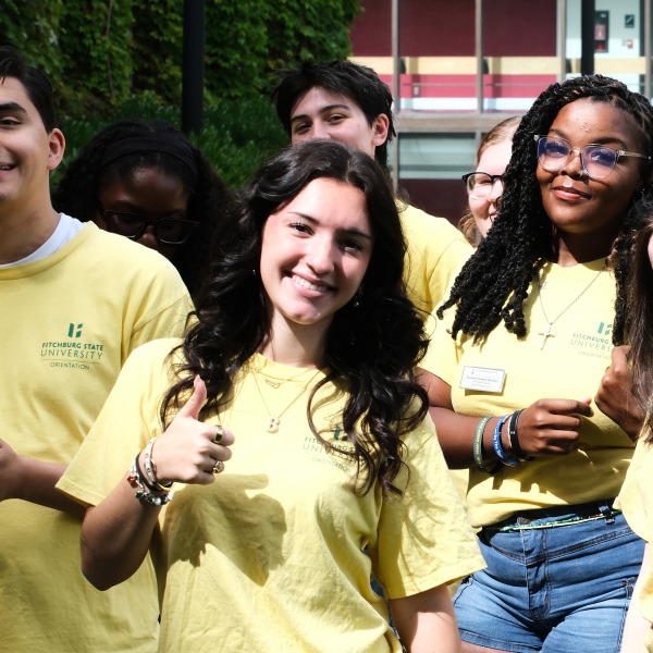 Orientation leaders smiling outside.
