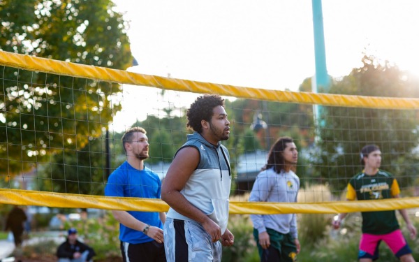students play volleyball on campus 