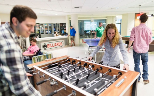 Students playing foosball in the campus game room