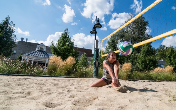 Students play volleyball on campus 