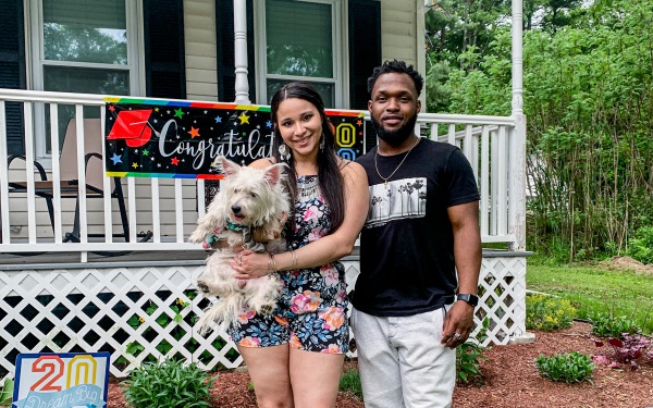 Graduate celebrating in advance of commencement at home