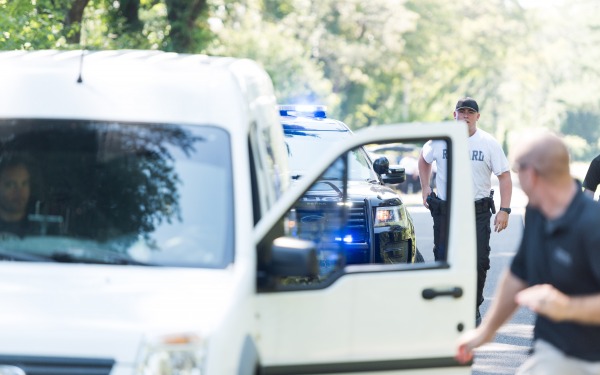 Police student approaching stopped car on the side of the road driver fleeing