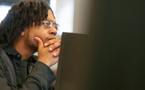 Student behind a computer screen in the classroom