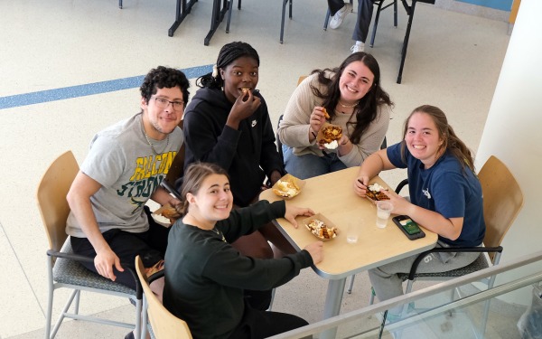 Students from above sitting at table in Hammond eating french fries