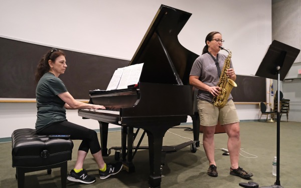 Music teachers rehearsing on piano and saxophone in Kent Recital Hall
