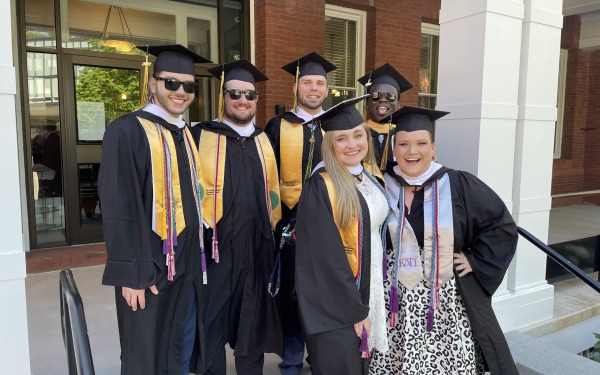 May 2022 History Student Graduates on steps of Miller Hall