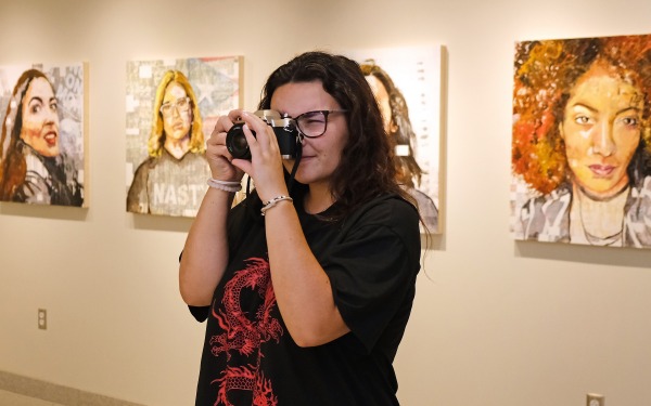 Girl taking photo in the art gallery