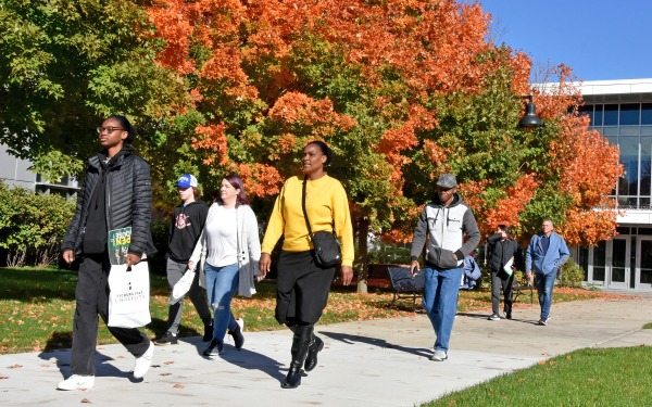 Tour groups on quad in front of Science building with fall foliage
