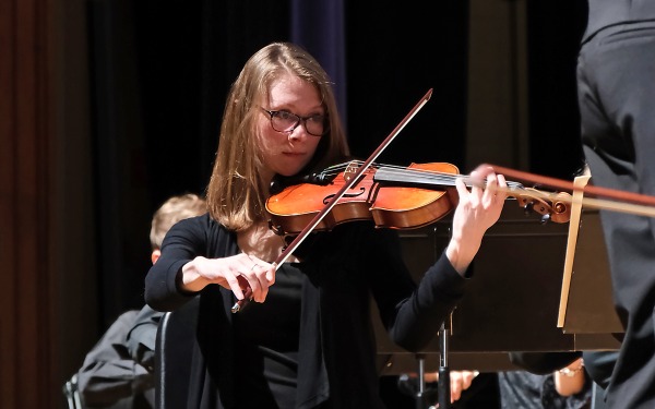 Violinist playing at concert in Weston