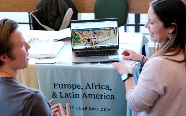 ISA rep presenting on computer to a student the opportunities to study abroad
