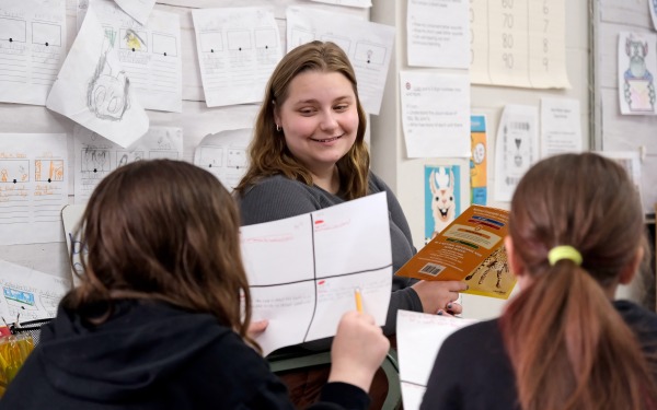 Student teaching at McKay reading to two female students