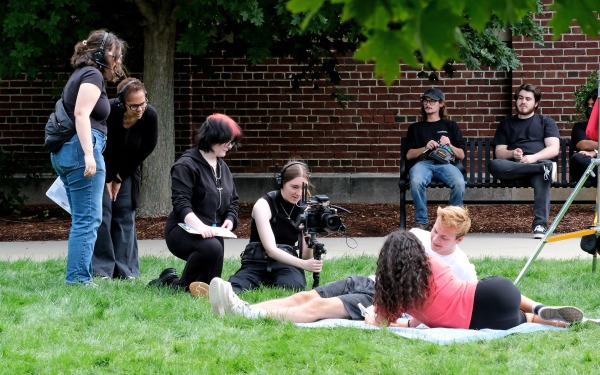 Toni Magras filming with students on the quad
