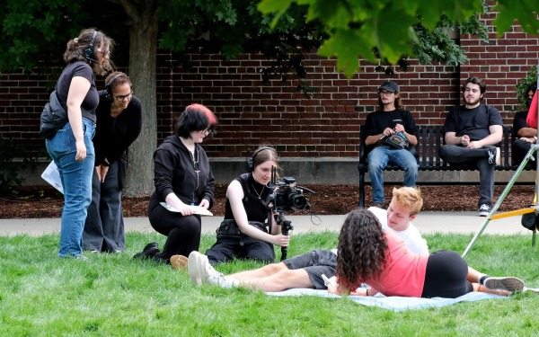 Toni Magras filming with students on the quad