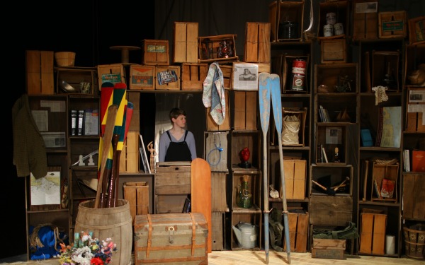 Set of Dead Mad with boxes and shelves and student in middle