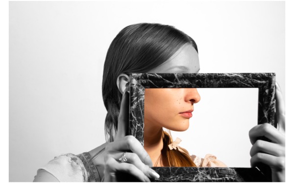 Profile of girl holding frame black and white and color