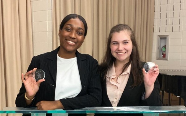 2019 moot court Crystal and Sam at podium with medals