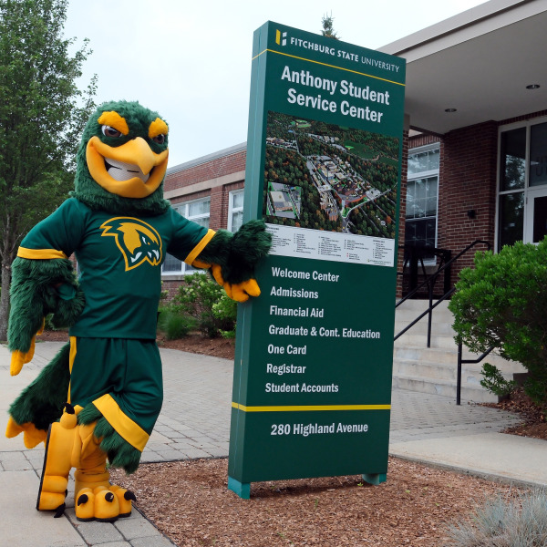 Freddy in front of Anthony Student Center with sign