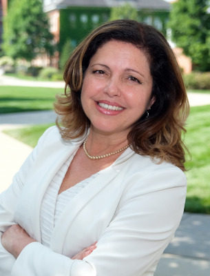 Ana Mesquita-Emlinger, headshot outside on campus.