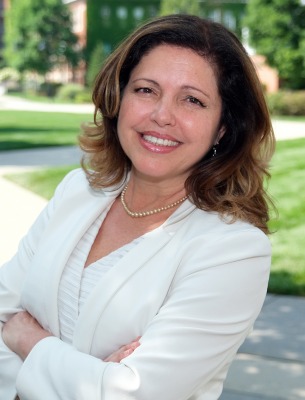 Ana Mesquita-Emlinger, headshot outside on campus.