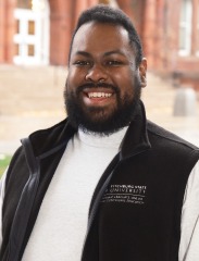 Portrait of Juan Orta in front of Thompson Hall.