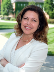 Ana Mesquita-Emlinger, headshot outside on campus.