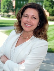 Ana Mesquita-Emlinger, headshot outside on campus.