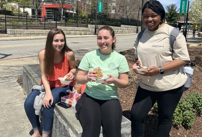 Students eating ice cream in front of Hammond with Russell Towers in background