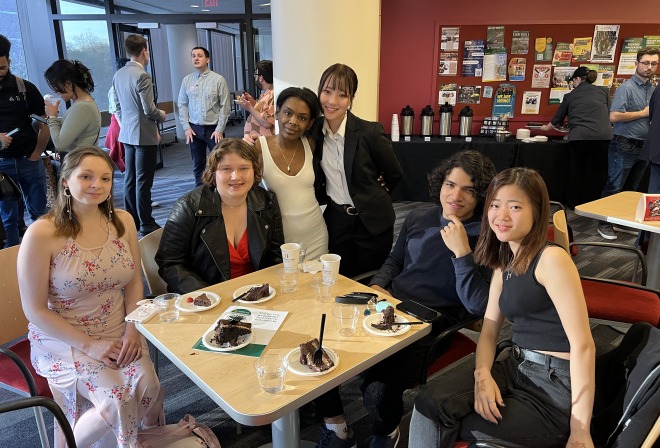 Group of diverse students in hammond with cake celebrating recognition night