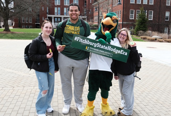 Students on the quad with Freddy holding Hodge Era sign
