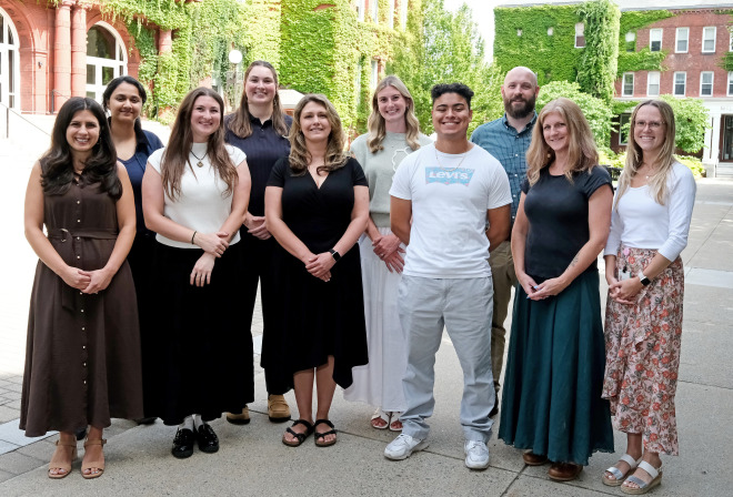 Group photo of the counseling services staff in front of Thompson and Miller Hall.