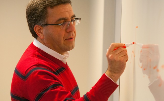 Professor writing on board 