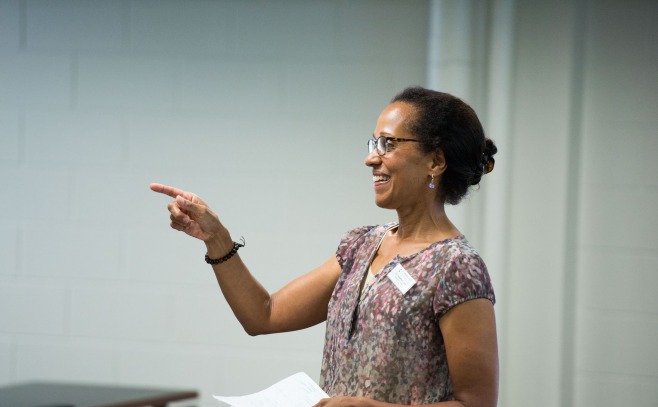 A teacher points encouragingly to a student 