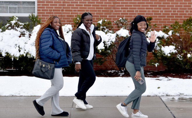 Three female students walking in front of Dupont