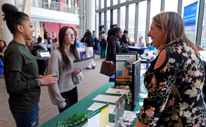 Students talking to SGOCE staff member at career fair