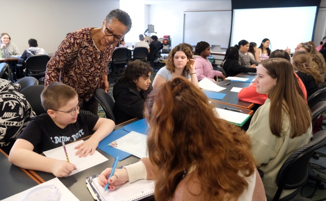 Danette Day talking with elementary students in classroom