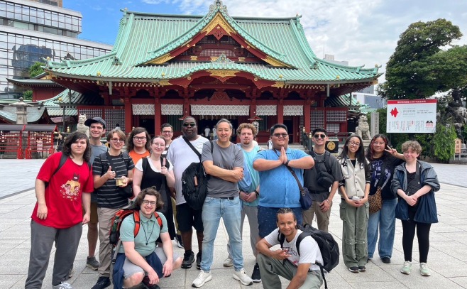 Group of game design students in front of Japanese building while abroad in Japan.