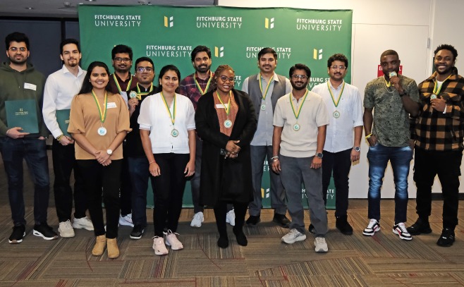 International graduates with medals at awards ceremony in main lounge.